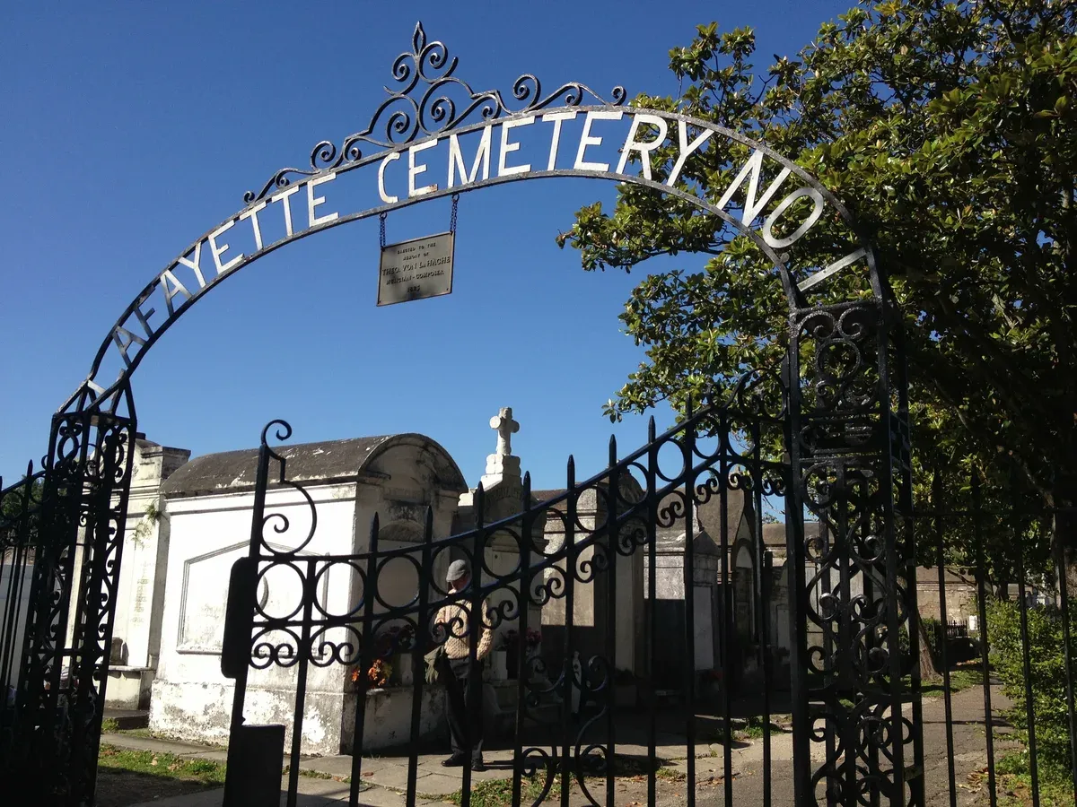 The iron arch of Lafayette Cemetery No. 1 in the Garden District, a cemetery near New Orleans ghost tours